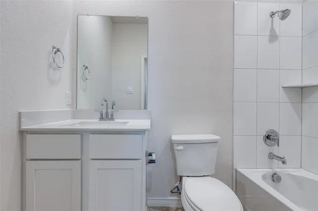 a bathroom with a toilet sink shower and mirror