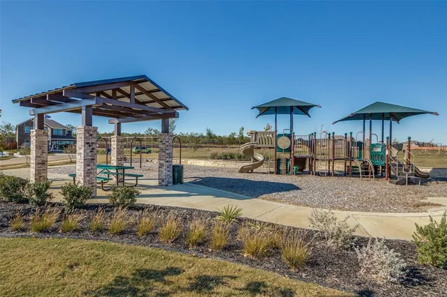 a view of a table and chairs under an umbrella