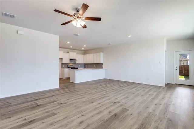 a view of kitchen with granite countertop cabinets and wooden floor