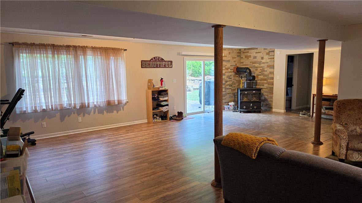 3733 Viewpoint Court Slatington, PA 18080 - Photo 18 of 25 A well-lit recreational space features laminate flooring and a cozy fireplace with direct outdoor access.