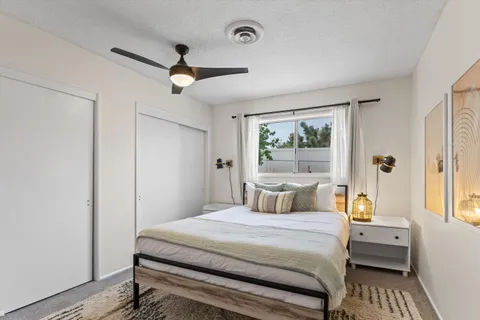 a bedroom with a large bed and a window