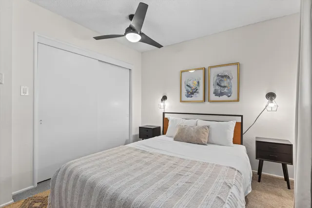 a bedroom with a bed and a table