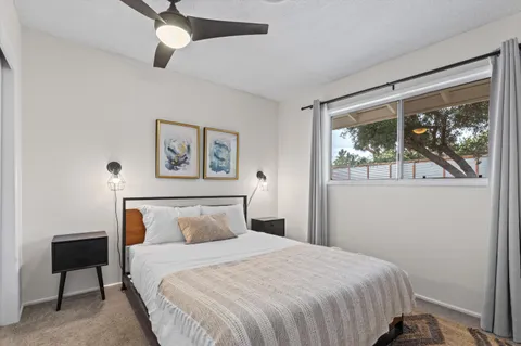 a view of house with backyard and furniture