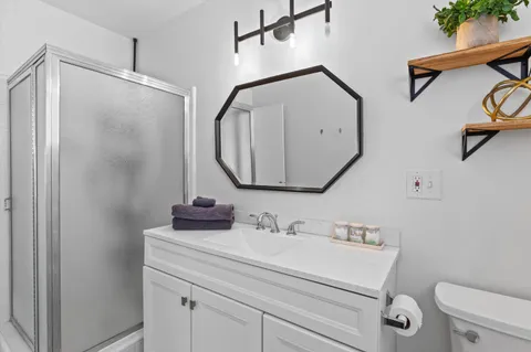 a view of a house with lounge chairs in patio