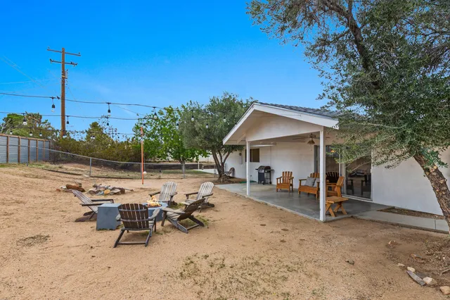 a view of a house with lounge chairs in patio