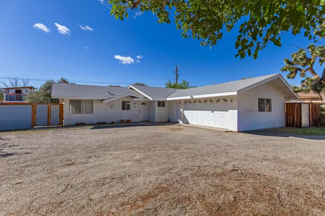 a house with yard and a wooden fence