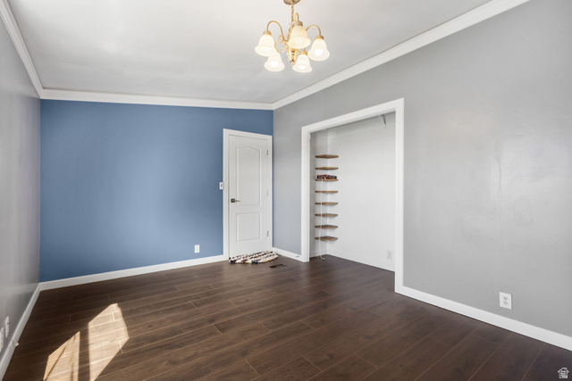 2600 North Hill Field Road, Unit 86 Layton, UT 84041 - Photo 15 of 25 Spare room featuring ornamental molding, dark wood-type flooring, and a chandelier
