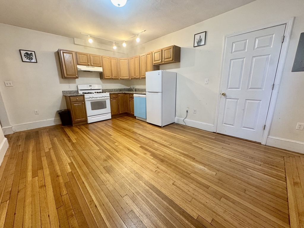 1615 Commonwealth Avenue, Unit 11 Boston, MA 02135 - Photo 5 of 9 a kitchen with stainless steel appliances a refrigerator and a stove