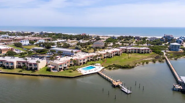 an aerial view of residential houses with outdoor space