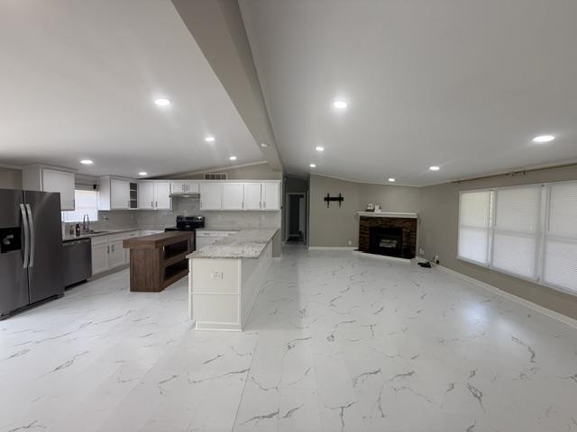 229 Coats Road Brighton, TN 38011 - Photo 3 of 14 Open-concept living space featuring expansive white marble-patterned flooring, recessed lighting, and a fireplace