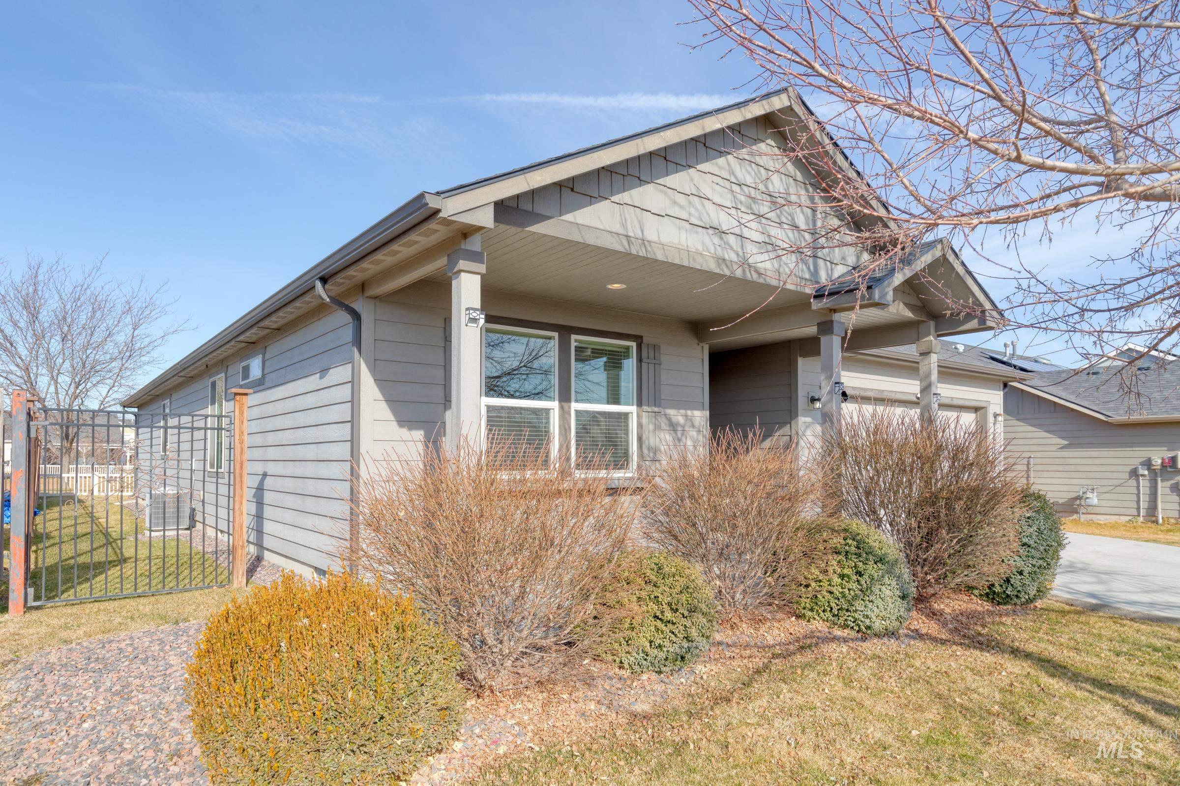 12734 Amber Sky Drive Caldwell, ID 83607 - Photo 3 of 28 View of property exterior with an attached garage and a cooling unit