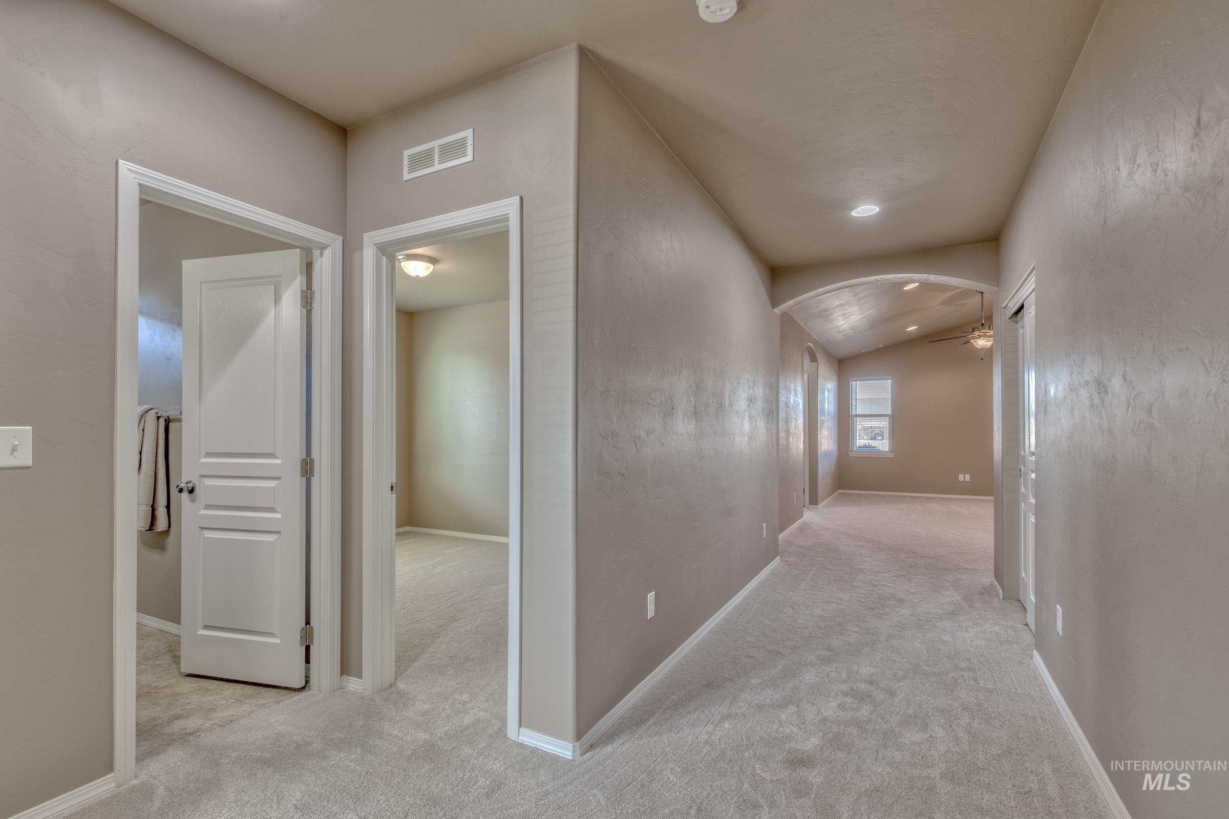 12734 Amber Sky Drive Caldwell, ID 83607 - Photo 4 of 28 Hall featuring lofted ceiling, arched walkways, carpet floors, and recessed lighting