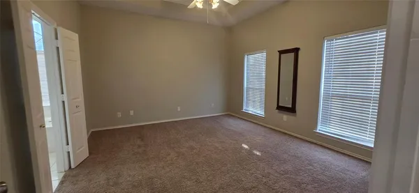 a view of a livingroom with an empty space and a window
