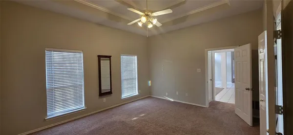 a view of a room with a ceiling fan and a window