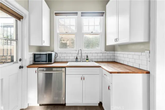 a kitchen with stainless steel appliances granite countertop a refrigerator and a stove