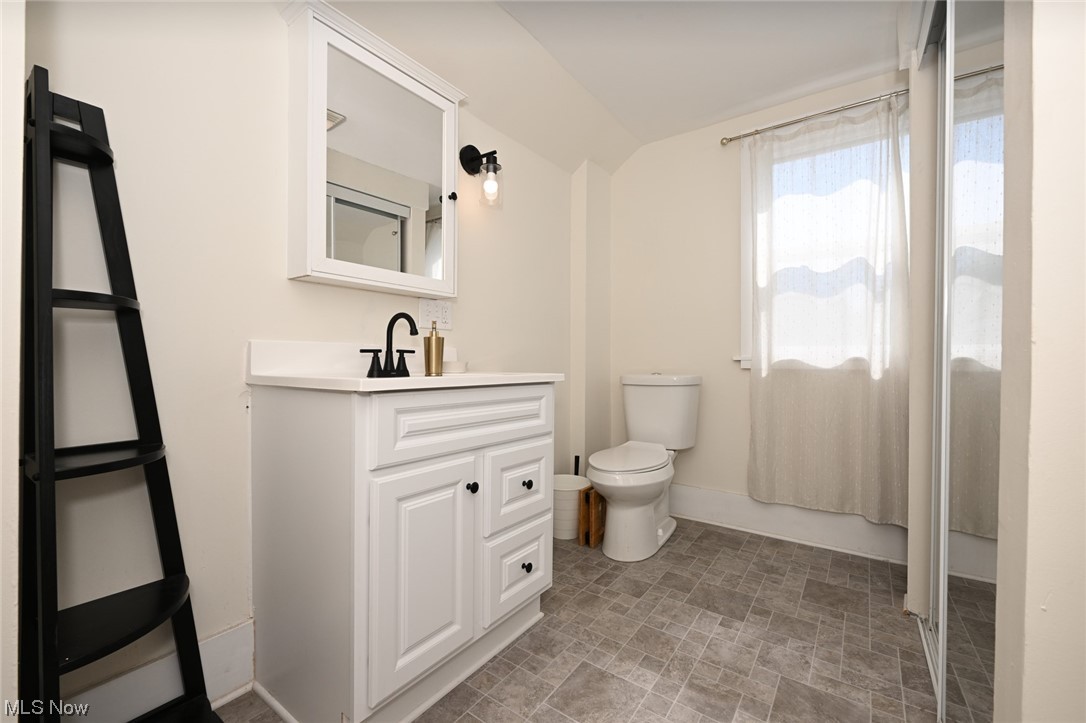 181 Swartz Road Akron, OH 44319 - Photo 21 of 23 Upstairs half bath is huge with large, mirrored linen closet along wall.