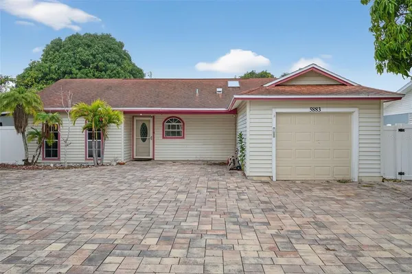 a view of a house with a yard and garage