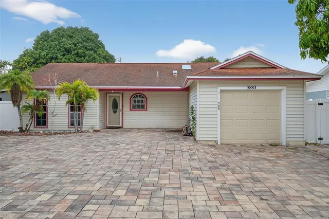a view of a house with a yard and garage