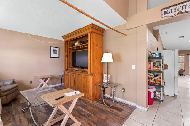 a kitchen with lots of appliances a sink a counter top space cabinets and stainless steel appliances