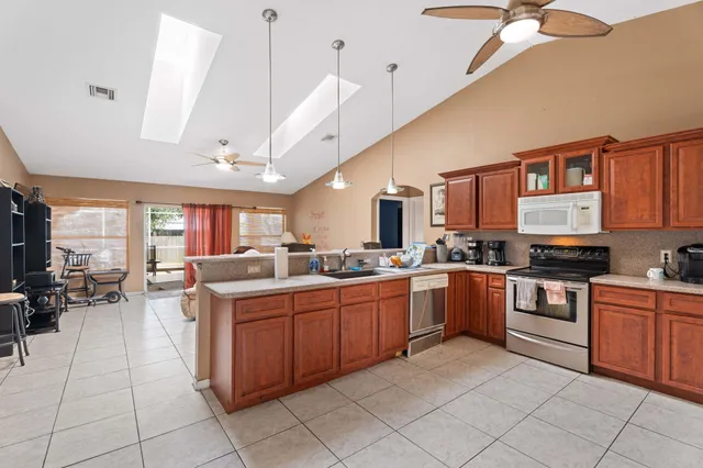 a kitchen with stainless steel appliances granite countertop a refrigerator and a stove