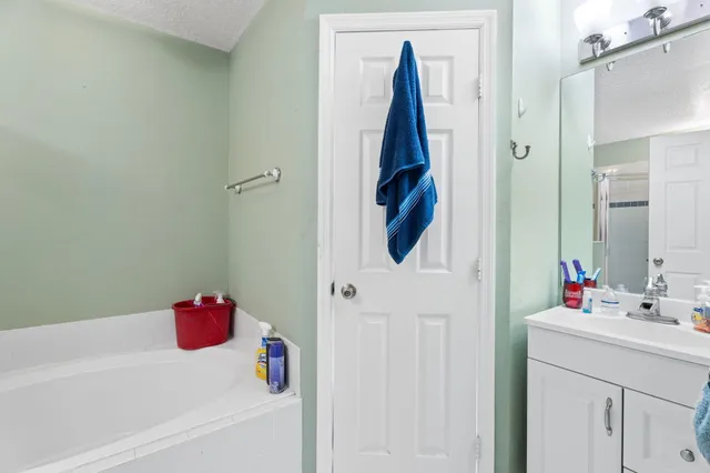 a living room with furniture kitchen view and a chandelier