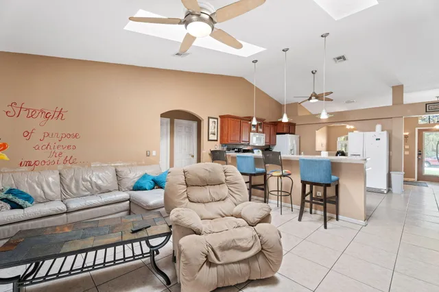 a bathroom with a granite countertop sink a toilet a mirror and shower
