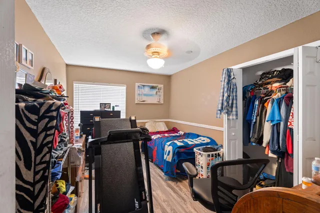 a bedroom with a bed and a chandelier