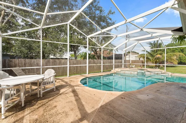 a view of a swimming pool with an outdoor seating