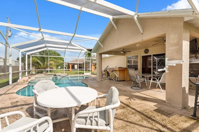 a view of a patio with table and chairs and potted plants