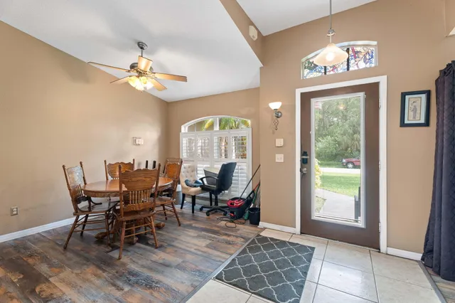 a view of a dining room with furniture a chandelier and wooden floor