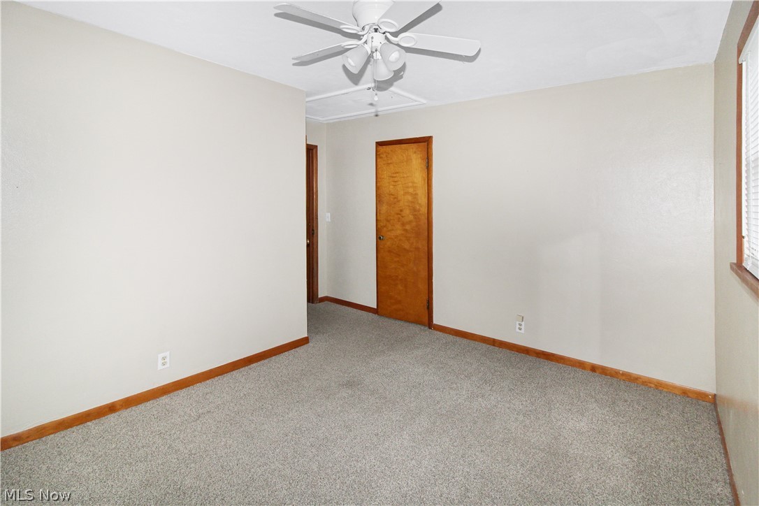 1036 West Fremont Road Port Clinton, OH 43452 - Photo 19 of 32 Unfurnished room with light carpet and ceiling fan