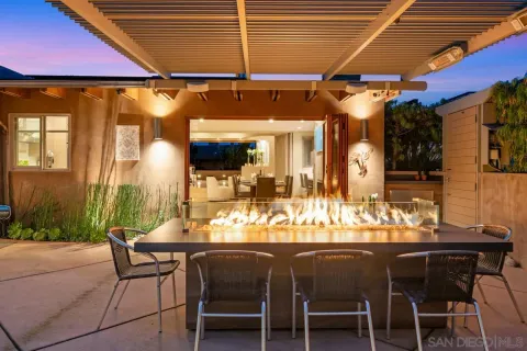 a dining area with a table and chairs
