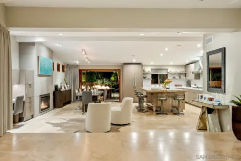 a living room with lots of furniture and kitchen view