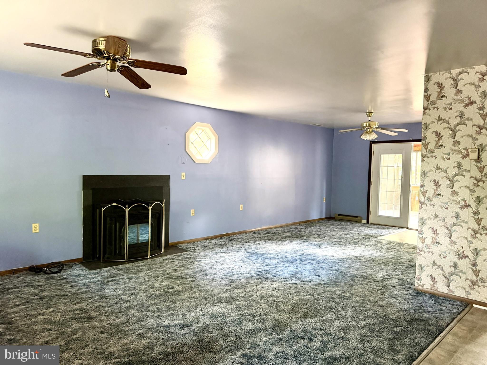 25910 Fox Grape Road Greensboro, MD 21639 - Photo 12 of 27 a view of a livingroom with a fireplace and window