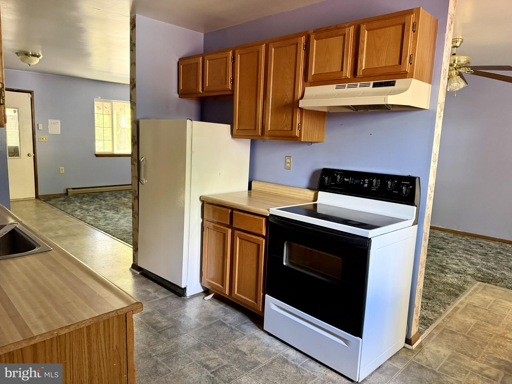 25910 Fox Grape Road Greensboro, MD 21639 - Photo 16 of 27 a kitchen with stainless steel appliances granite countertop a stove a microwave and a sink