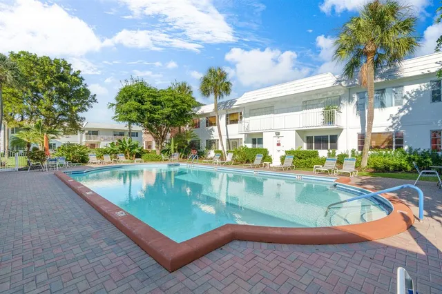 a view of a swimming pool with outdoor seating