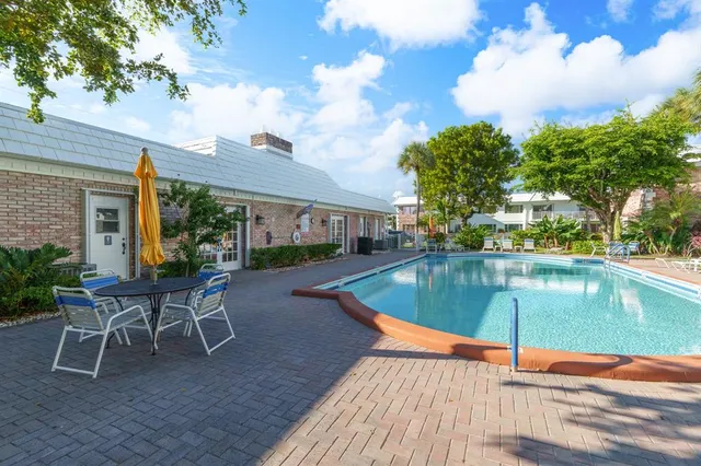 a swimming pool with outdoor seating and yard
