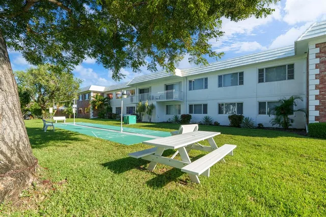 a view of a house with a yard patio and swimming pool