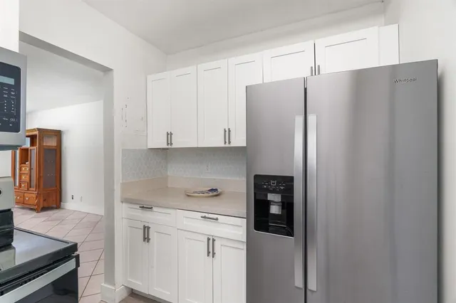 a kitchen with stainless steel appliances a refrigerator and cabinets