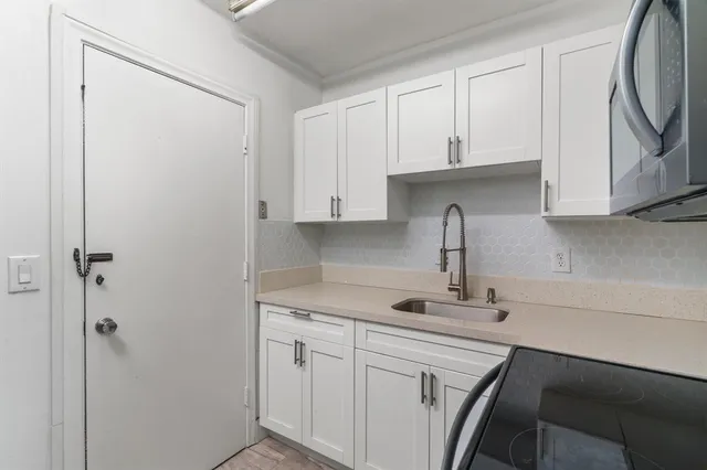 a kitchen with a sink and cabinets