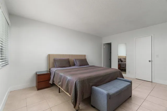 a bedroom with a bed and a view of bathroom