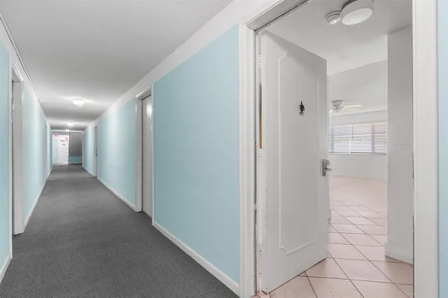 a view of hallway with a bathroom