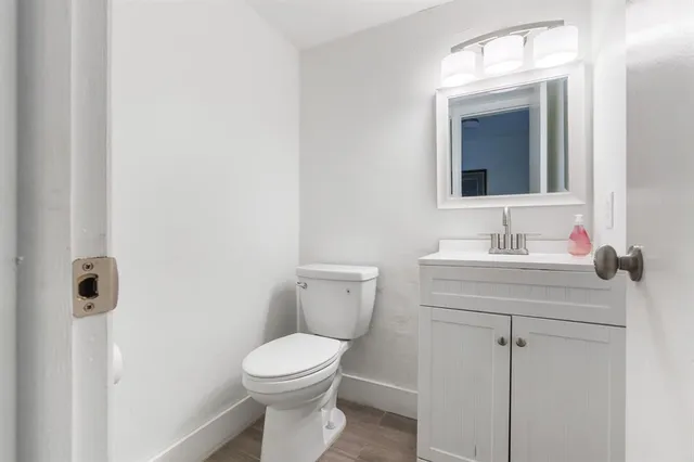 a bathroom with a toilet sink and mirror