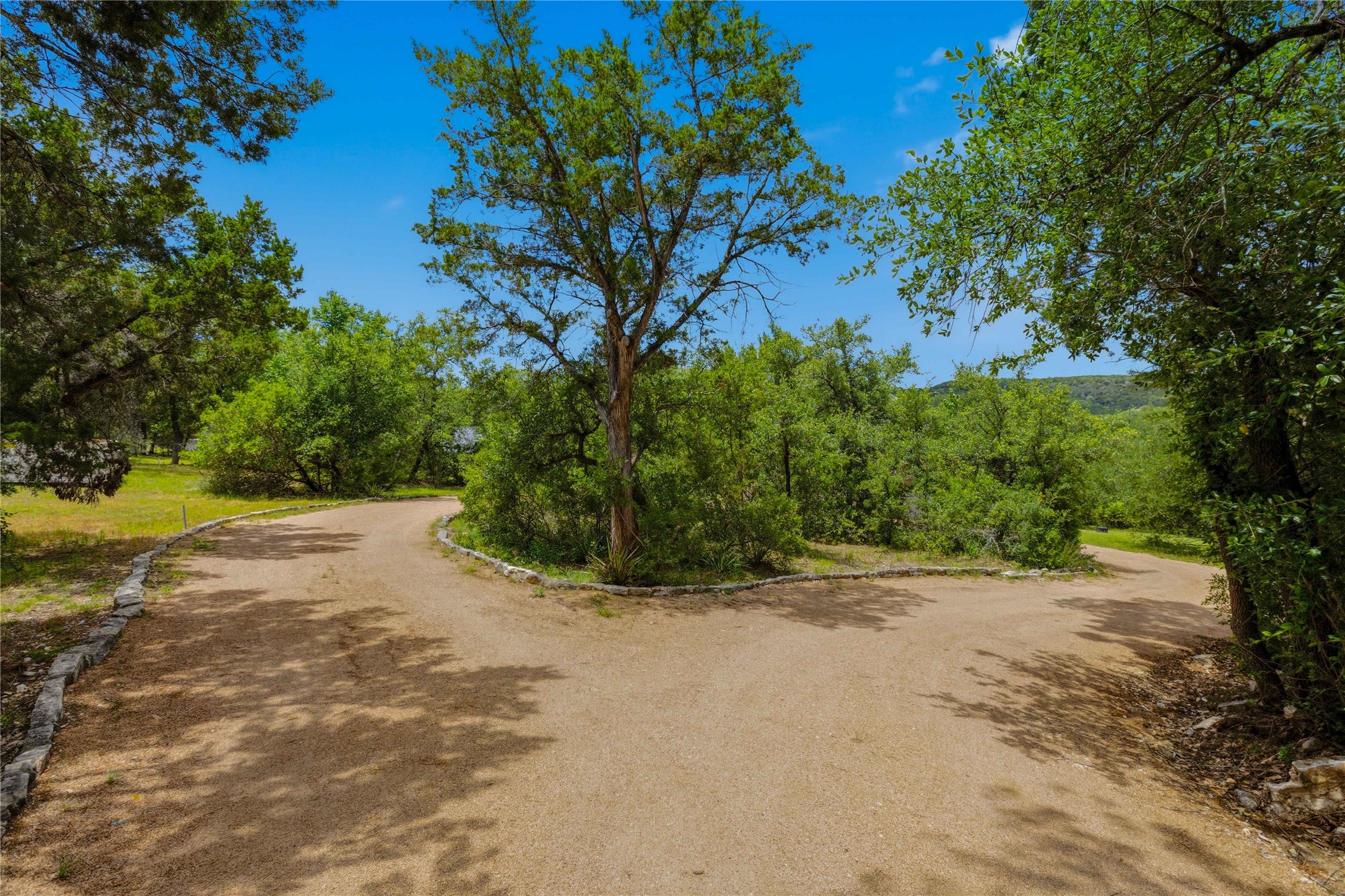 8122 Lime Creek Road Volente, TX 78641 - Photo 3 of 40 The private driveway to this secluded home