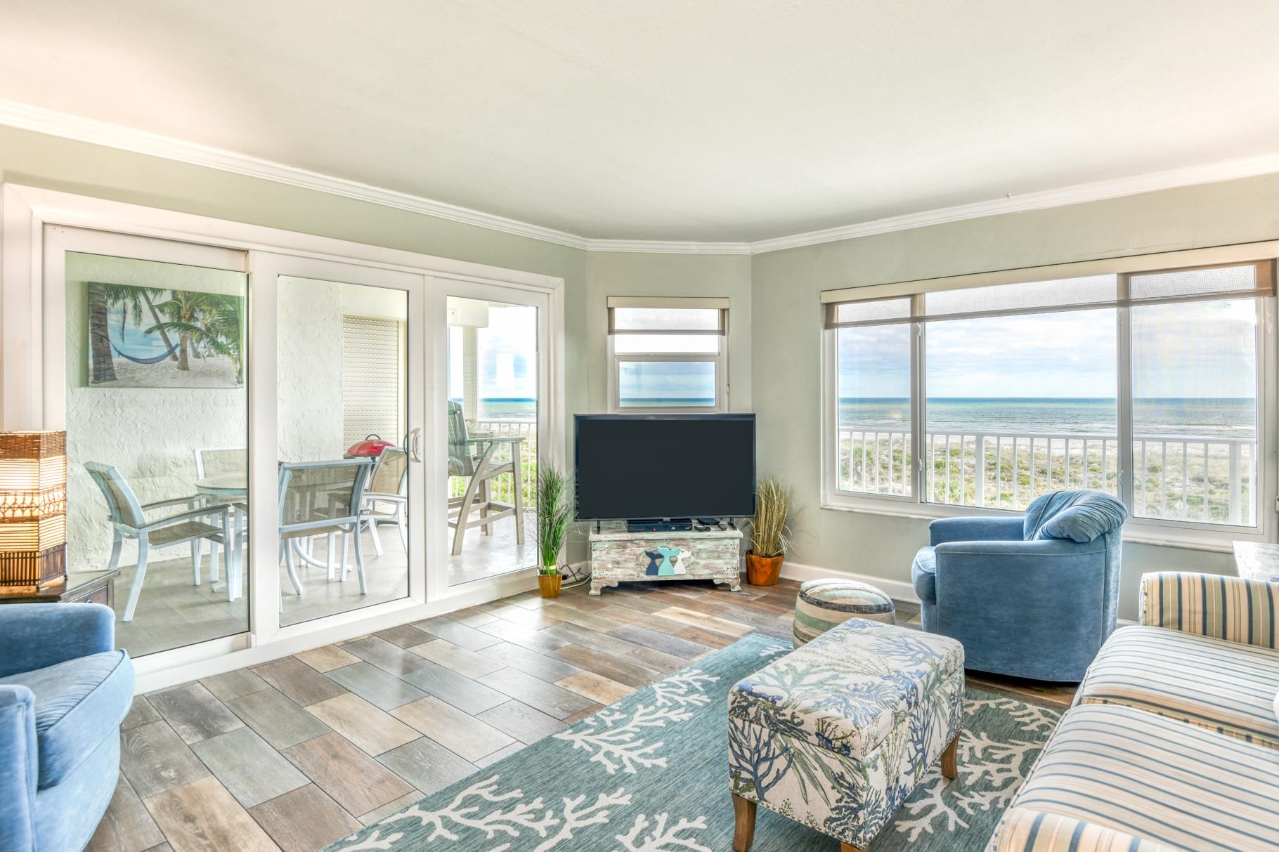 4670 A1A South, Unit 1402 St. Augustine, FL 32080 - Photo 10 of 47 a living room with furniture a flat screen tv and large windows