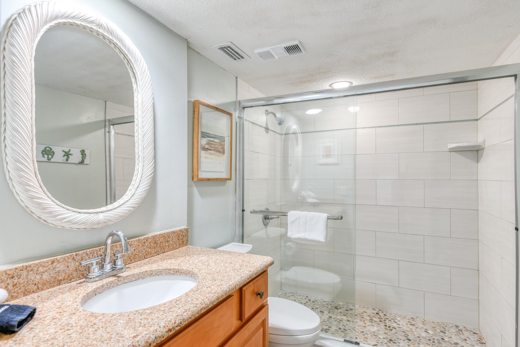 4670 A1A South, Unit 1402 St. Augustine, FL 32080 - Photo 21 of 47 a bathroom with a granite countertop sink toilet a mirror and shower