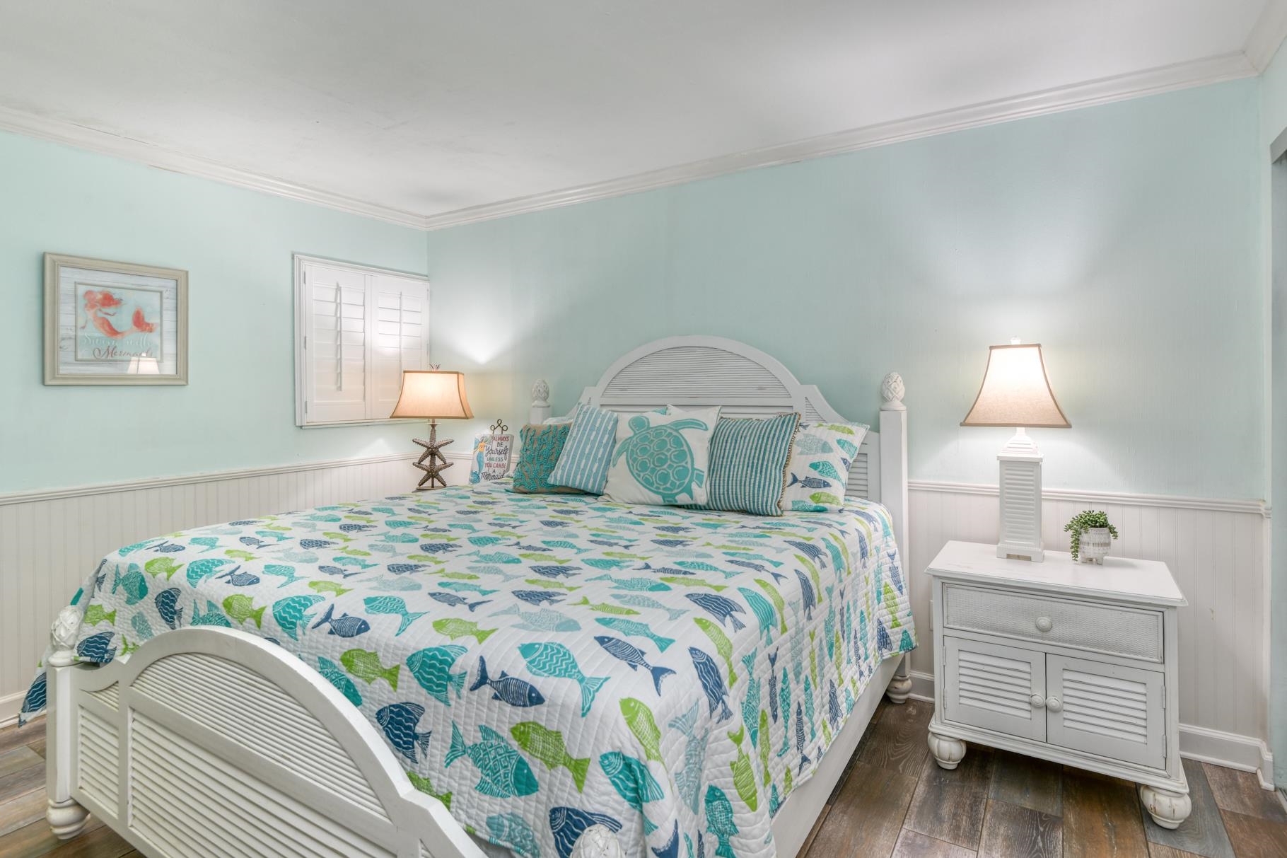 4670 A1A South, Unit 1402 St. Augustine, FL 32080 - Photo 22 of 47 a bedroom with a bed and a lamp on dresser