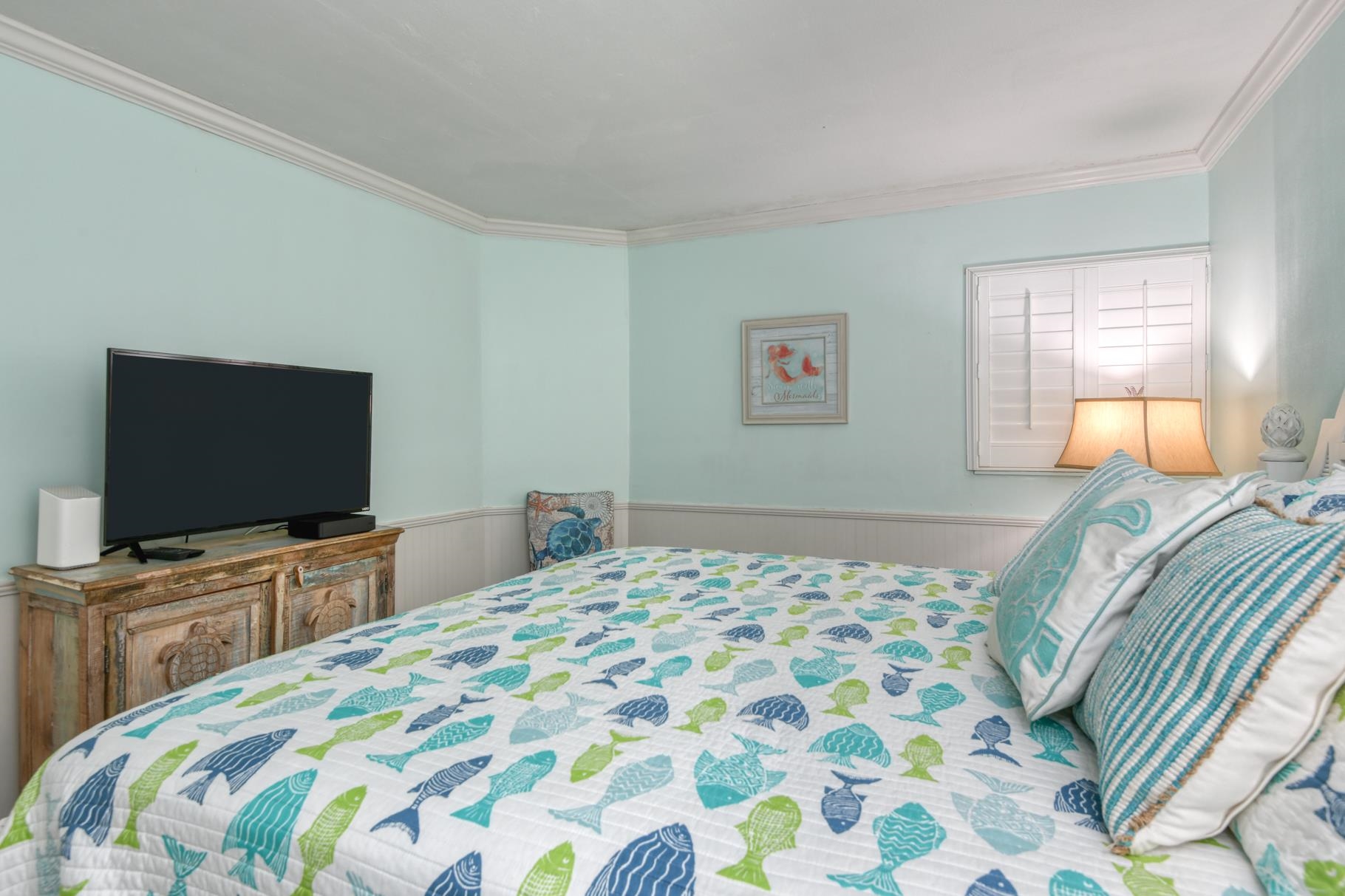 4670 A1A South, Unit 1402 St. Augustine, FL 32080 - Photo 23 of 47 a bedroom with a bed and a flat screen tv