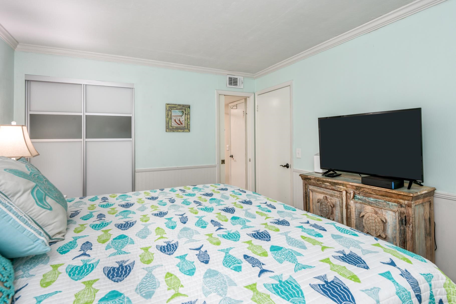 4670 A1A South, Unit 1402 St. Augustine, FL 32080 - Photo 24 of 47 a bedroom with a bed and a flat screen tv in it