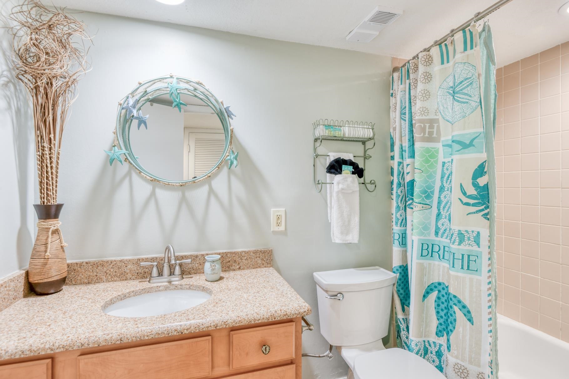 4670 A1A South, Unit 1402 St. Augustine, FL 32080 - Photo 25 of 47 a bathroom with a granite countertop toilet a sink and a mirror
